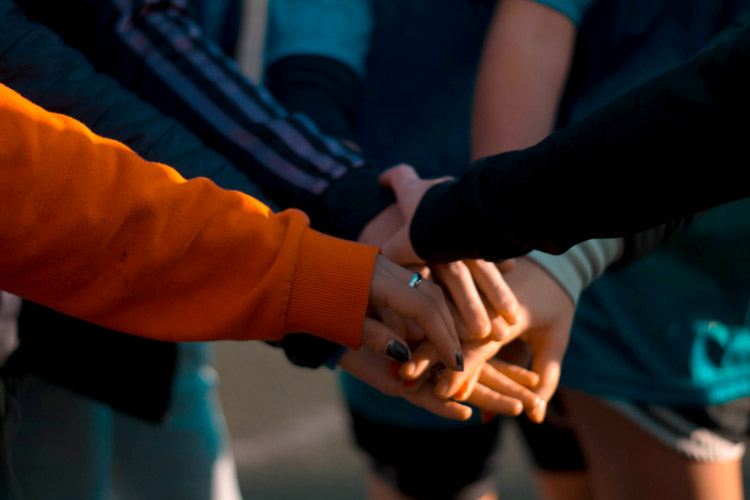 Hands together during a team huddle